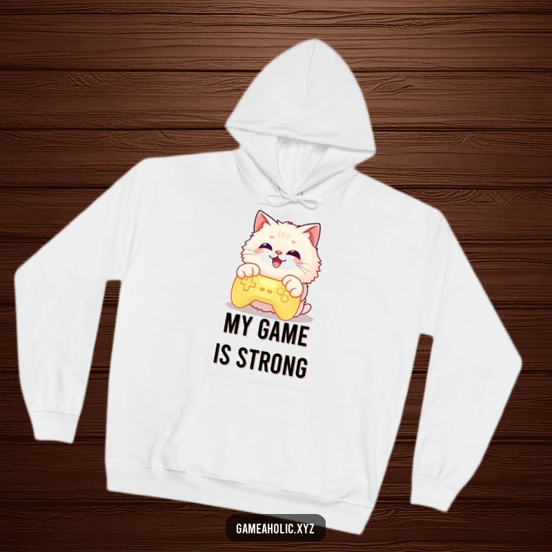 Fluffy cat character with paws on a glowing game controller, grinning widely, featured on a warm hoodie, perfect for gamers.